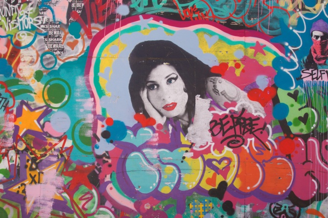 Mural of Amy Winehouse, with several other drawings around it.