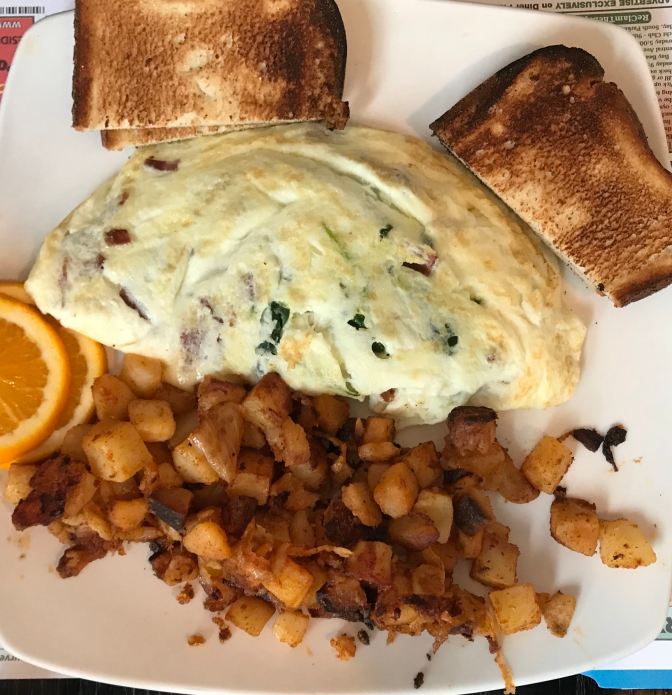Omelette with toast and home fries.