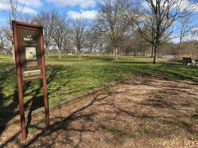 Small plot of ground with sign beside it indicating exercise directions.