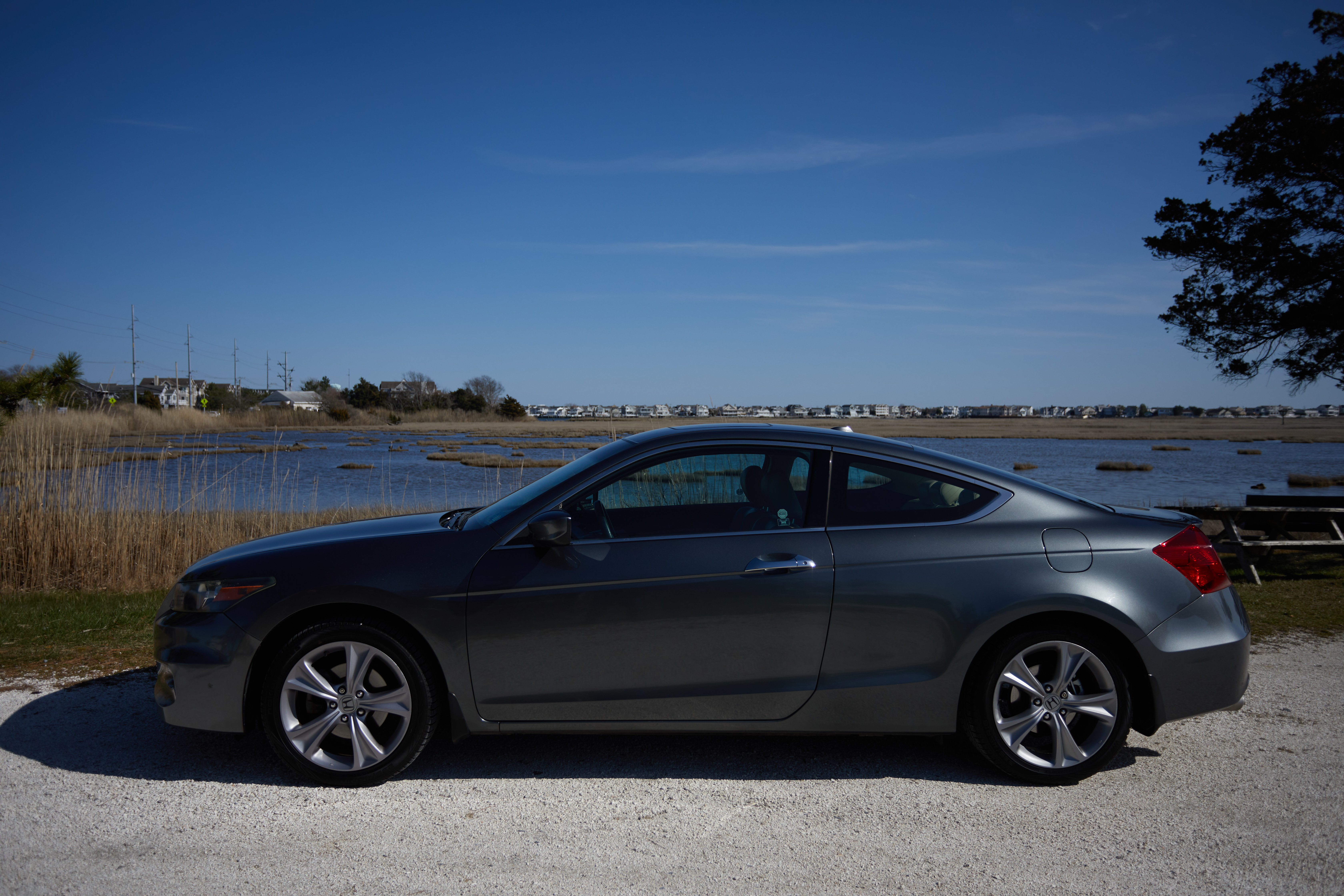 2012 Honda Accord parked in front of tidal marsh.