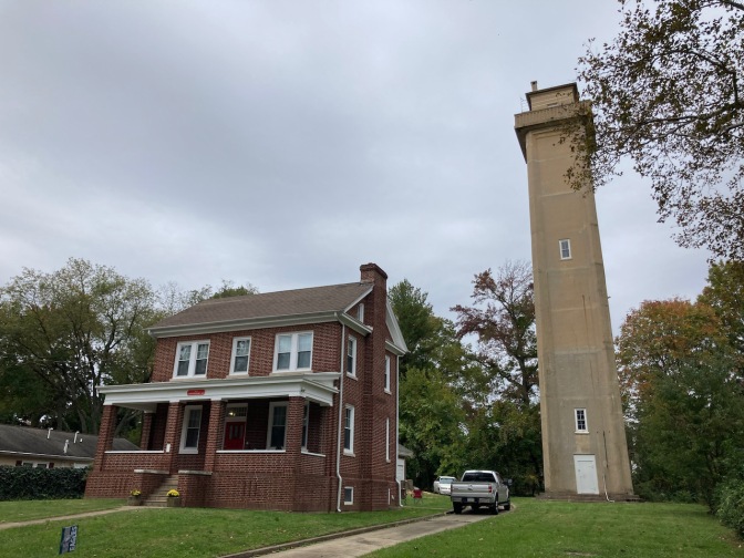 Marcus Hook Lighthouse beside two-story brick house. 