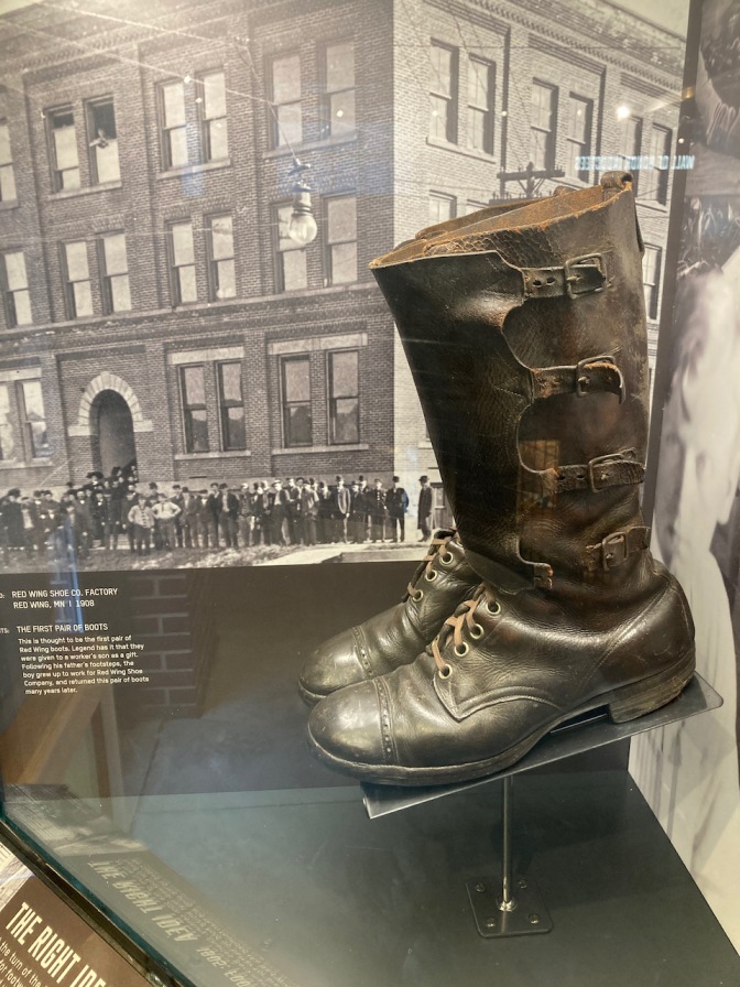 Pair of leather boots in glass display case.