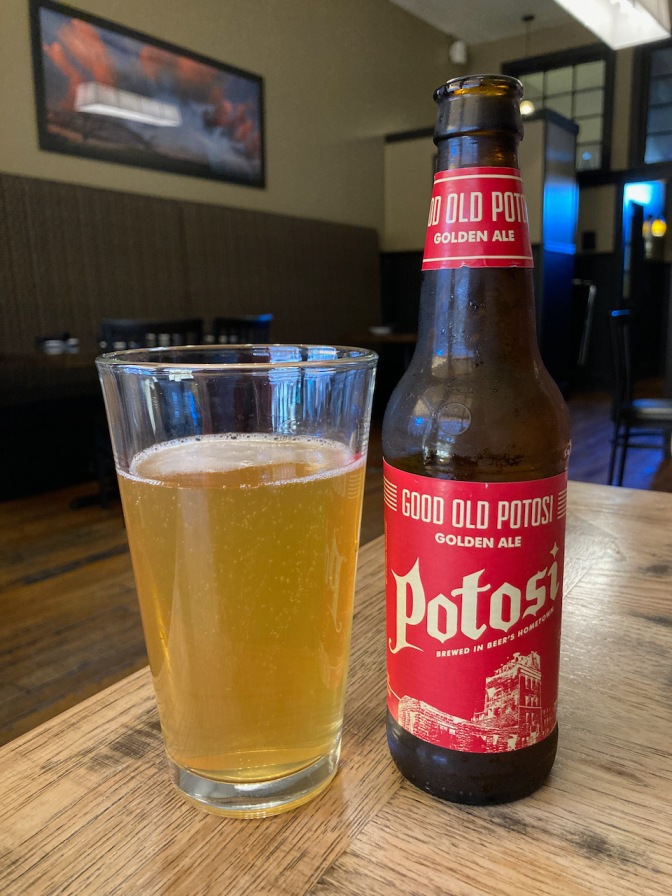 Bottle of Potosi Golden Ale on table.