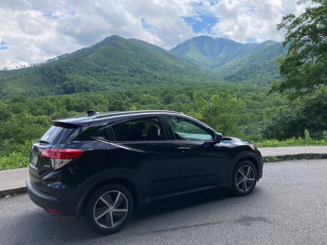 2021 Honda HR-V parked in turnout with mountains in distance.