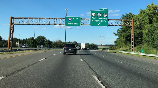 I-78 with signs over highway for Newark, NJ and Phillipsburg/Bloomsburg, NJ.